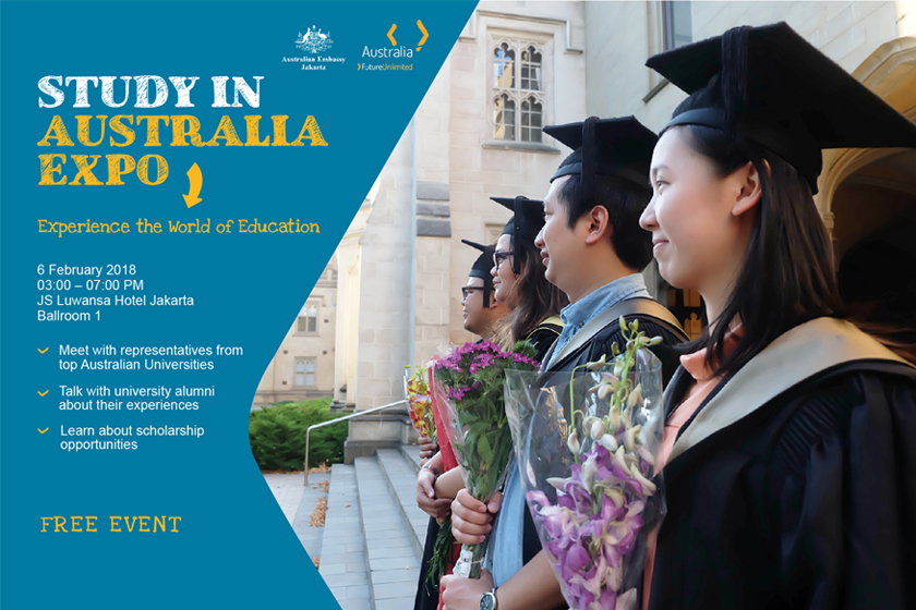 A group of graduating students holding bouquets of flowers